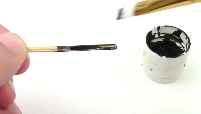 Make a cat toy stick by painting a dowel black.