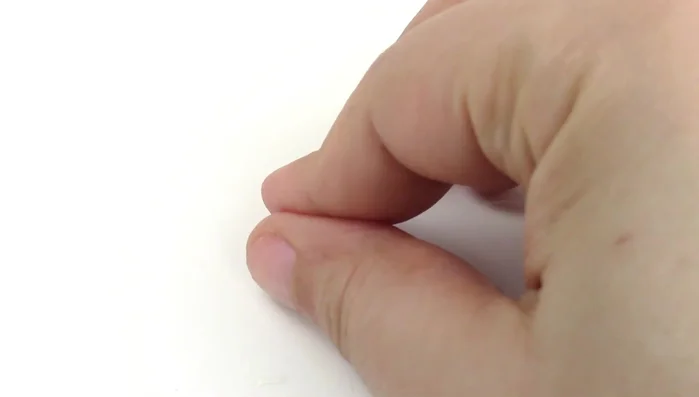 Create a miniature mouse toy using polymer clay. Bake for 20 minutes at 275°F. Add details and attach feathers to the back.