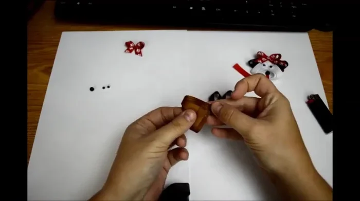 Assemble the head: Hold the body with the curve upward, fold over, and glue the point to the center of the body. This creates the space for the face.