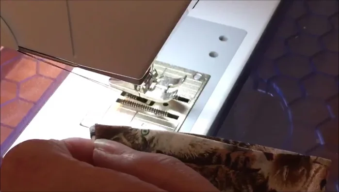 Line up one short end, pin it in place, and edge stitch close to the end, back tacking at the beginning. Sew this end closed.