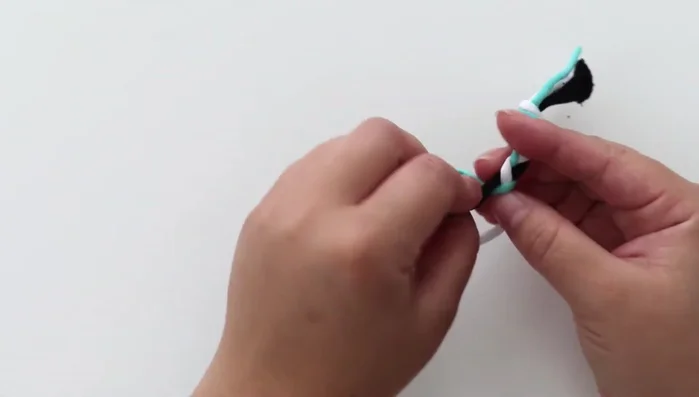 Braid each group of three strings until you reach the end, and tie another knot.