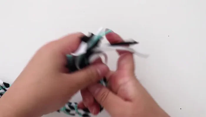 Continue weaving until you reach the end of the rope. Untie the individual braids and tie the entire rope together. Trim the rope edges.