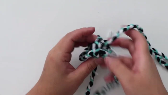 Continue weaving until you reach the end of the rope. Untie the individual braids and tie the entire rope together. Trim the rope edges.