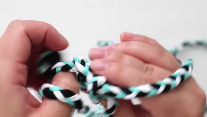 Continue weaving until you reach the end of the rope. Untie the individual braids and tie the entire rope together. Trim the rope edges.