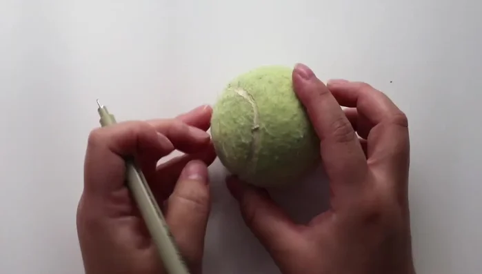 Cut out a square shape, connecting the lines, and carve out the excess rubber. Do this on both sides.