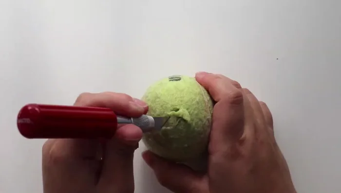 Cut out a square shape, connecting the lines, and carve out the excess rubber. Do this on both sides.