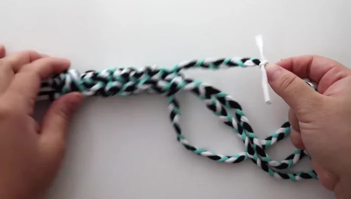 Weave the rope together in the same pattern as the first toy, tying a tight knot a few inches before the halfway point.
