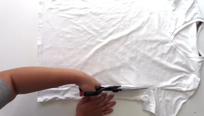 Cut four strips of t-shirt yarn (or additional fabric) slightly longer than the shortest fabric pieces from steps 1 and 2.