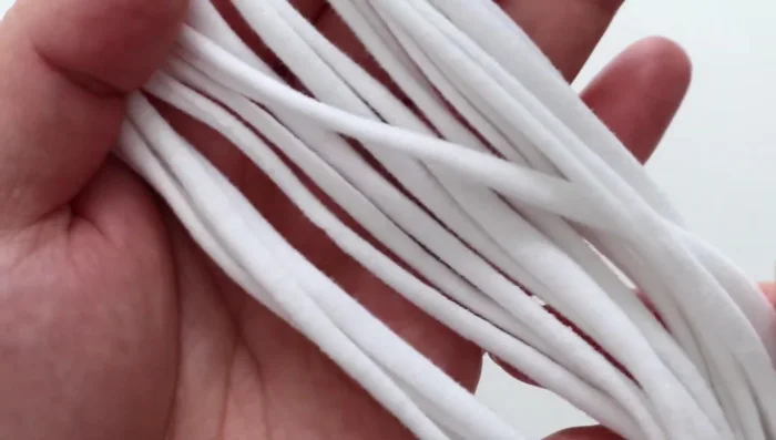 Stretch all 12 strips to create rope strings.