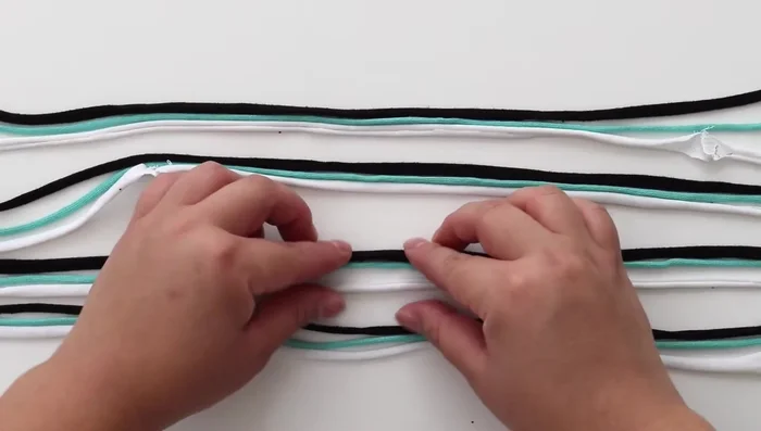 Braid each group of three strings until you reach the end, and tie another knot.