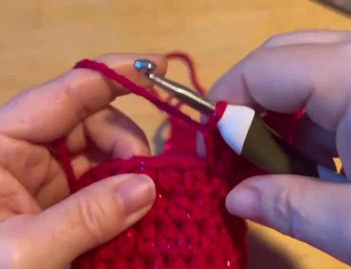 Slip stitch to join the chest to the back of the sweater, pulling the tail tight and tucking it down the center.