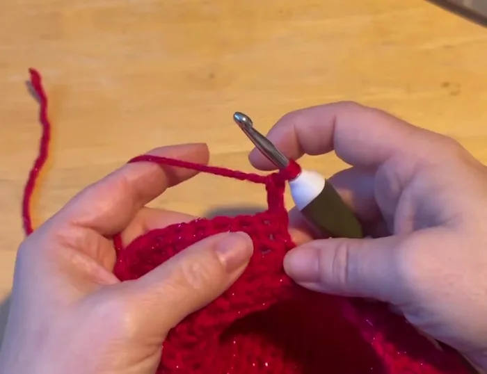 Slip stitch to join the chest to the back of the sweater, pulling the tail tight and tucking it down the center.