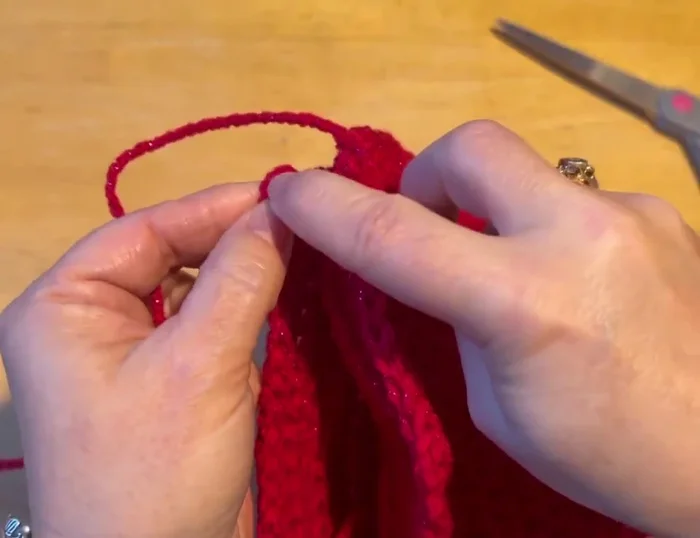 Slip stitch to join the chest to the back of the sweater, pulling the tail tight and tucking it down the center.