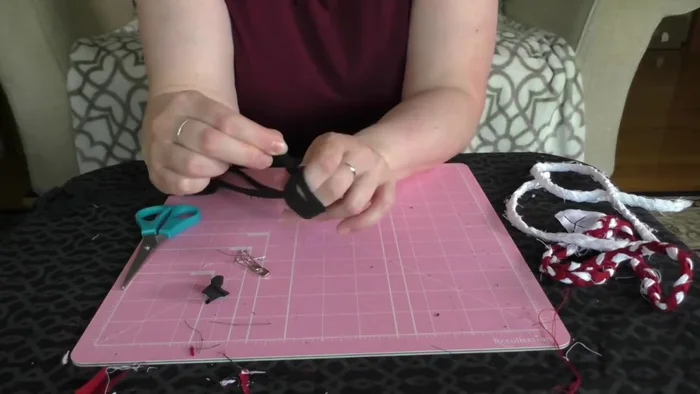 Attach the knotted end to something heavy (like a couch arm) to keep it in place.