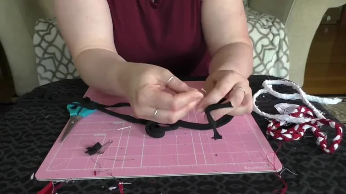 Attach the knotted end to something heavy (like a couch arm) to keep it in place.