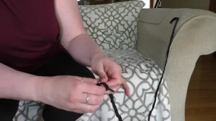 Tie another knot at the end of the braid.