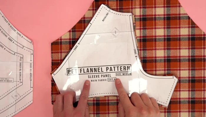 Assemble the body: Attach sleeves to main body panel at 1/4 inch seam allowance, topstitch for extra strength. Attach chest panels to the neckline at 1/4 inch seam allowance, topstitch for extra strength. Sew side seams at 1/4 inch seam allowance, topstitch for extra strength. Repeat for second body assembly.