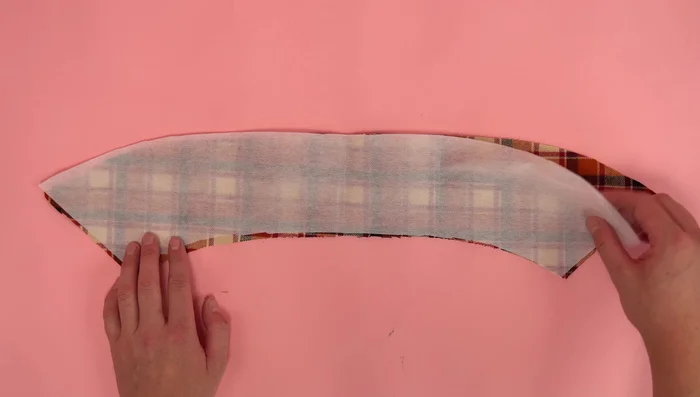 Assemble the collar: Place interfacing (if using) on the wrong side of one collar panel. Attach second collar panel, right sides together. Stitch, leaving the bottom open. Clip corners, flip right side out, topstitch around the outside edge.