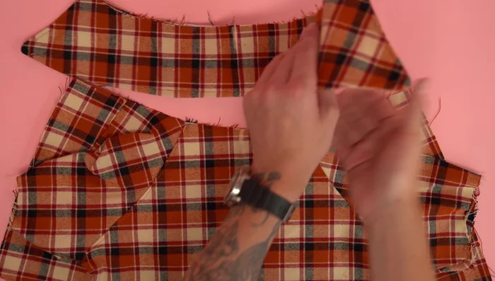 Attach collar to body: Center collar and body panels, stitch close to the edge. Attach second body assembly, right sides together, stitch at 1/4 inch seam allowance. Stitch the bottom edge of the collar to the bottom edge of the body panels.