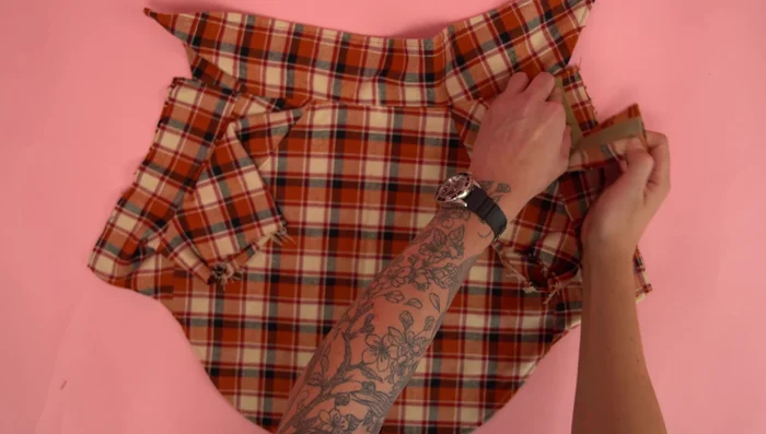 Attach velcro panels: Overlap velcro panels (one with velcro up, one with velcro down), stitch raw edges at 1/4 inch seam allowance. Finish raw edges with a serger or zigzag stitch to prevent fraying.