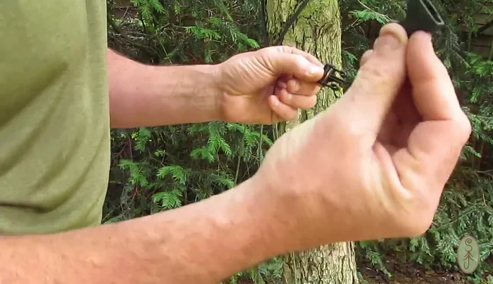 Thread the female part of the plastic buckle through the loop and over the clip to create a secure handle.