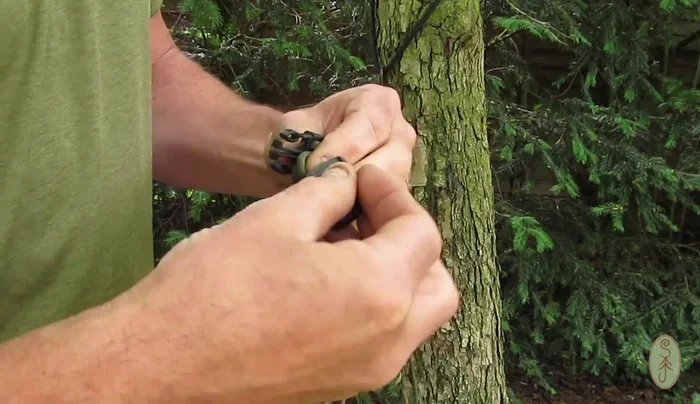 Thread the female part of the plastic buckle through the loop and over the clip to create a secure handle.