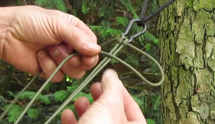 Begin the Solomon weave: create a loop with one working end, pass it over the top of the two main strands, and then thread the other working end through the loop. Repeat this process, alternating sides, until you reach the male clip.