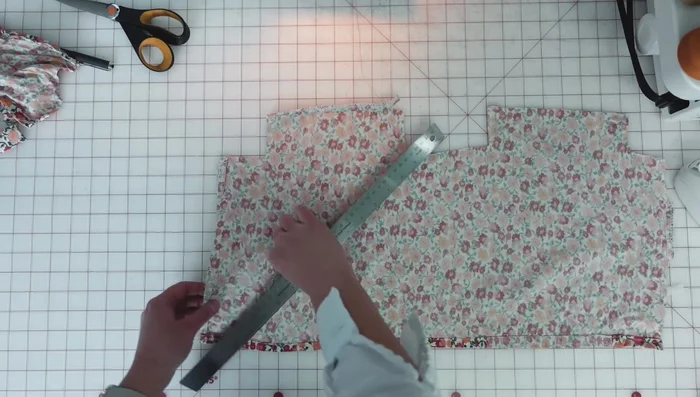 Create and attach bias binding: Cut bias strips, join them, press seams open, and attach to the perimeter of the coat.