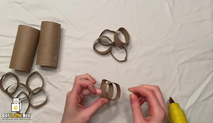 Glue the rings together to form a ball.