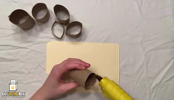 Glue toilet paper tubes to the envelope/paper.