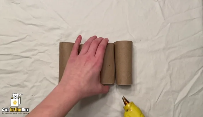 Glue four toilet paper tubes together to form a stable base.