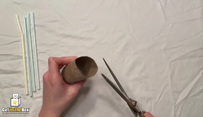 Cut diagonal slits into the toilet paper tube.