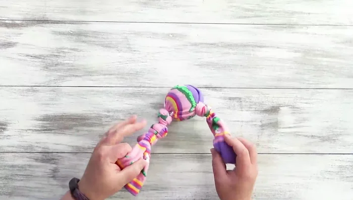 Tie the two remaining ends of the sock together in a square knot.