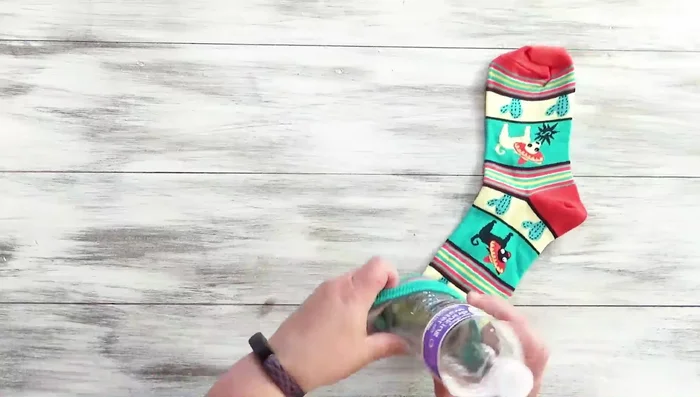 Insert the plastic bottle into the sock up to the heel.