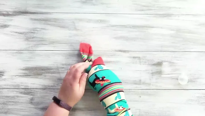 Stuff the sock with polyfill and insert the squeaky toy into the middle.