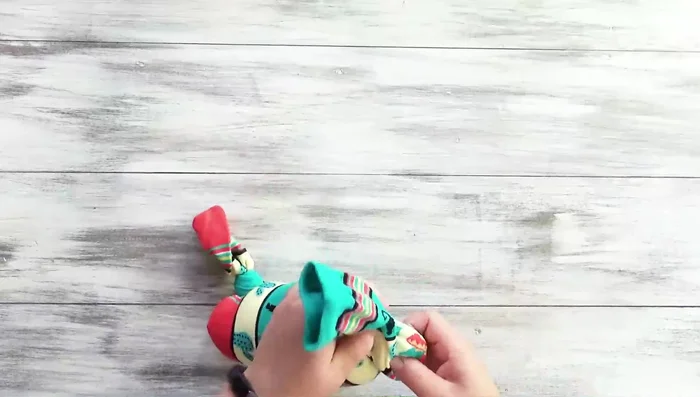 Tie a knot to close the toy.