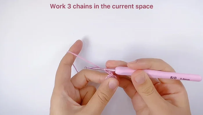 Make flower petals: Work 3 chains, then 3 unfinished double crochets in the same space. Repeat this sequence to create 5 petals. Pull through all loops to finish each petal.