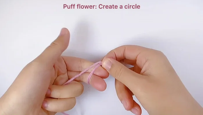 Make flower petals: Work 3 chains, then 3 unfinished double crochets in the same space. Repeat this sequence to create 5 petals. Pull through all loops to finish each petal.