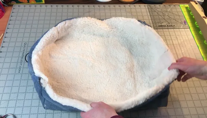 Turn right side out: Turn the bed right side out through one of the openings. Push out the corners to shape the bed.