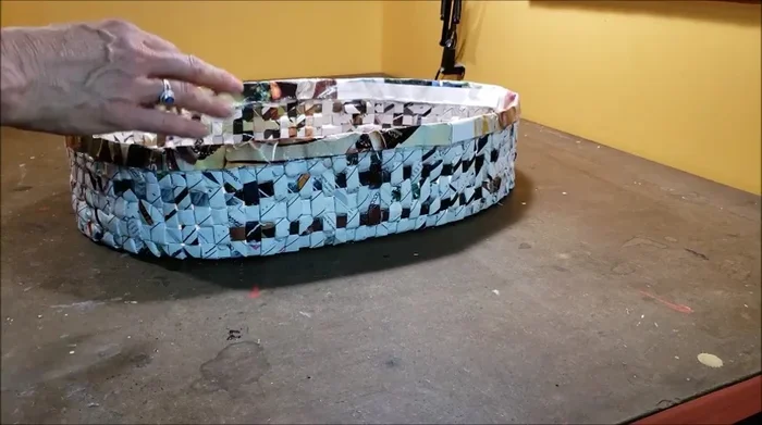 Spray paint the basket with metallic silver paint. Optionally, apply a distressed finish using diluted black paint and paper towels to create an antique look.