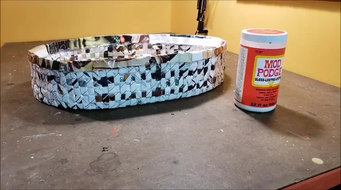 Spray paint the basket with metallic silver paint. Optionally, apply a distressed finish using diluted black paint and paper towels to create an antique look.