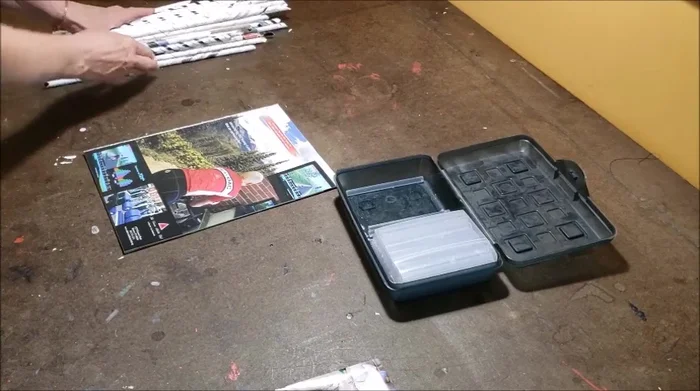 Roll tightly several pieces of magazine paper around a glue stick. Remove the glue stick and use a glue gun to secure the rolled ends.