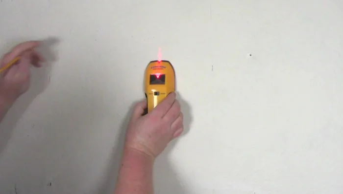 Locate studs in the wall using a stud finder. Pre-drill holes for screws.