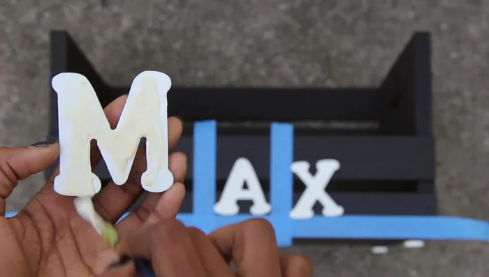 Apply wood glue to the back of each letter and press into place.