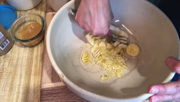 Gradually add 2 cups of ground organic oats and 1 teaspoon of cinnamon, mixing until a dough forms. Add more oats if needed to reach a workable consistency.