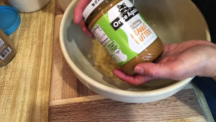 Gradually add 2 cups of ground organic oats and 1 teaspoon of cinnamon, mixing until a dough forms. Add more oats if needed to reach a workable consistency.