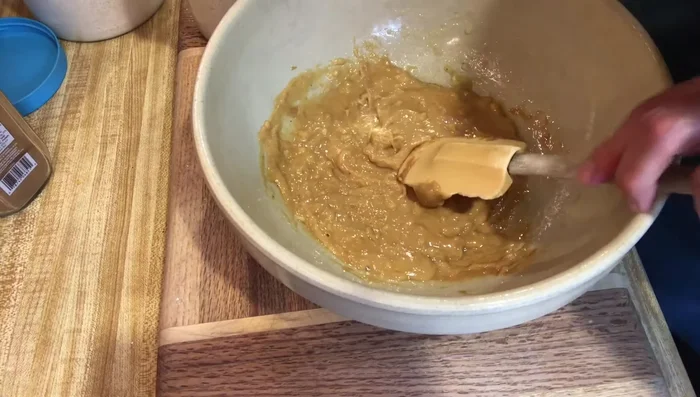 Gradually add 2 cups of ground organic oats and 1 teaspoon of cinnamon, mixing until a dough forms. Add more oats if needed to reach a workable consistency.