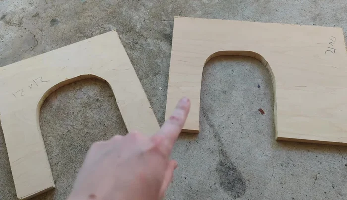 Create Cat House: Cut rounded openings for doors in the designated wood pieces. Sand all cut edges for smoothness.