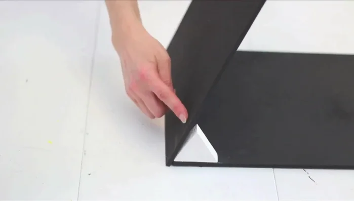 Assemble the A-frame roof. Place triangles on the outer edges of the first roof board, add the second roof board, and nail them together. Flip and repeat for secure fastening. A friend can help hold pieces.