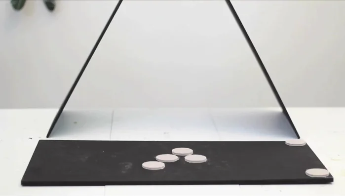 Attach the baseboard. Add felt pads to protect the floor. Flip and place the A-frame on top, connecting it with brackets or hinges. Position hinges to hide the knuckle and achieve the desired angle.